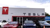 Tesla reports major drop in profit, delays unveiling of Robotaxi