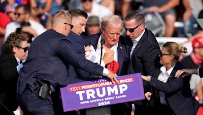 Photos show Trump with blood on his face after shots fired at rally
