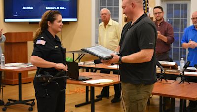 A neighbor and trio of Dalton police officers were recognized for saving residents from their burning home