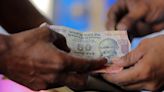 Rupee edges lower tracking Asian peers, forward premiums rise