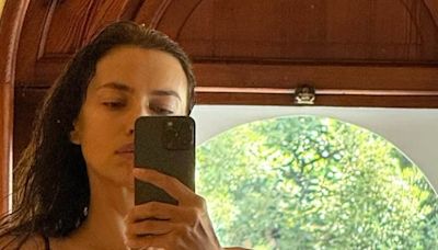 irina shayk shows off her extremely toned physique in black bikini