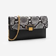 A crossbody clutch is a small, rectangular crossbody bag that is designed to be carried as a clutch or worn across the body with a long strap. It usually has a zip or snap closure and is often used for evening events or as a compact everyday bag.