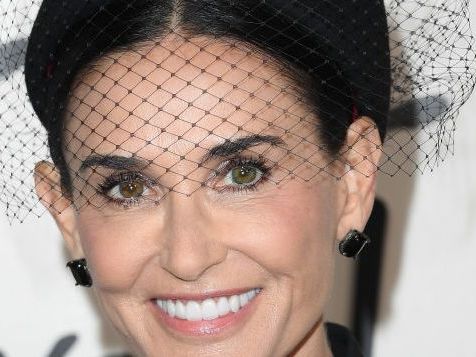 Demi Moore does Venetian carnival vibes in purple gown and masquerade mask
