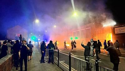 Moment thugs torch library and foodbank amid riots in Liverpool