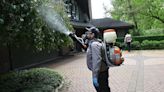 ...& Mosquito Control in Farmington Hills, Michigan, sprays the landscape of a home on West Lane Street in Dearborn, Michigan, on May 10, 2024.