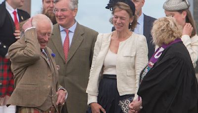 King Charles battles wind as he exits from a Church in Scotland