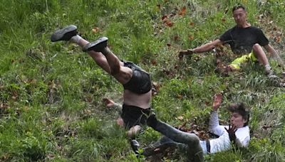 Best pictures from UK's crazy cheese rolling race