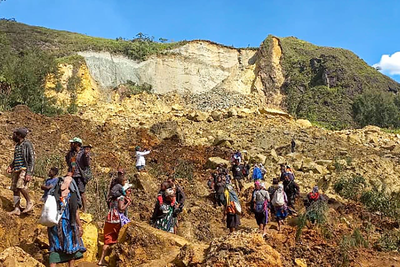 Papua New Guinea says Friday’s landslide buried more than 2,000 people and formally asks for help