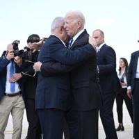 Israel Prime Minister Benjamin Netanyahu hugs US President Joe Biden upon his arrival at Tel Aviv's Ben Gurion airport on October 18, 2023