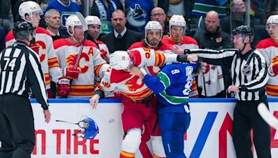 Photos: Canucks come out flying in scrappy home opener against Flames