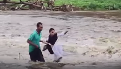 MP: School Girl Gets Stuck While Crossing Over-Flowing River Amid Heavy Rains, Rescued By Braveheart