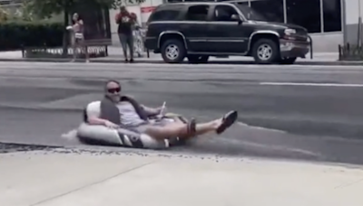 Atlanta resident floats down flooded street as city enters day five of water main breaks