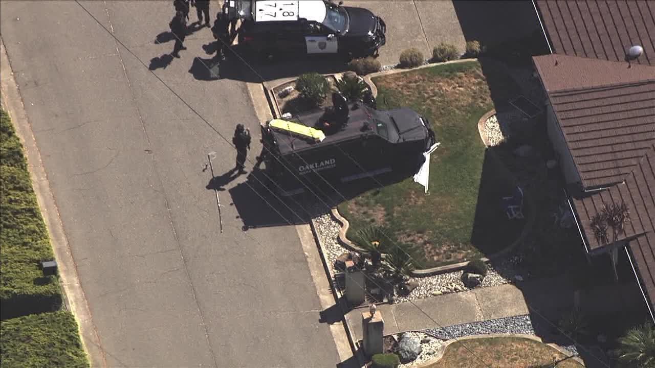 Oakland police respond with tactical vehicle at a home