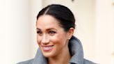 Meghan Markle's giant pearl earrings are the perfect accessory to her sleek bun as she surprises pregnant women with special treat