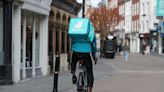 Deliveroo rider transports food on penny farthing bicycle in west London