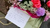 A message for Britain's Catherine, Princess of Wales, is placed on a bouquet of flowers near Windsor Castle, the day after news of Britain's Catherine's illness