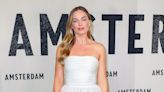Margot Robbie Wows in White at Amsterdam Premiere But Says Making Movies 'Isn't as Glamorous'