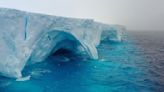 Striking photos show arches and cavernous hollows carved into world’s largest iceberg