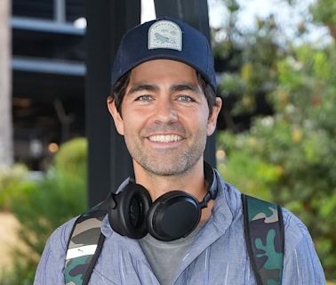 Adrian Grenier is all smiles as he touches down in Sydney