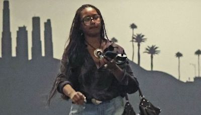 Sasha Obama looks thoughtful in cutoffs as she puffs on a cigarette