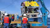 A robot is combing the sea floor for debris from the Titan submersible implosion as a multinational investigation begins