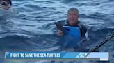 Reporter struggles to stay afloat during filming of sea turtle release
