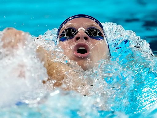 Paris Olympics: Léon Marchand lives up to the hype, and delights his native France — including President Macron