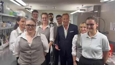 Kevin Costner visits kitchen staff during Berlin premiere of Horizon