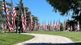 Avenue of Flags wave visitors into Decatur's Graceland Cemetery