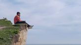 Dramatic pictures show sightseer dicing with death on crumbly chalk cliff