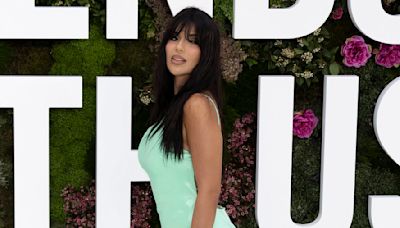 Ekin-Su Culculoglu flashes her legs in a thigh-slit green dress