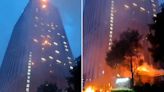 Towering inferno as massive fire on hotel sends flames dripping onto street