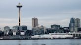 Photographs capture humpback whale's Seattle visit, breaching in waters in front of Space Needle