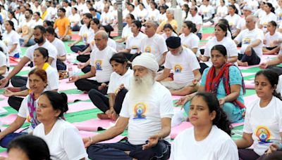 Dharamsala: People perform asanas to mark Yoga Day