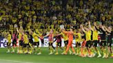 Soccer-Bundesliga pressure off Dortmund after win over PSG