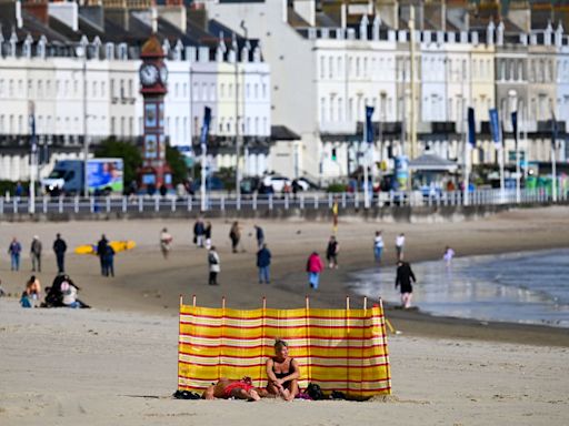 People return to UK beaches after cold snap gives way to warmer weather