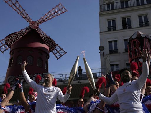 Artists, chefs, garbage collector among hundreds carrying the Olympic torch through Paris