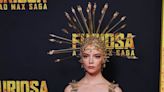 Anya Taylor-Joy wears a headpiece and matching naked dress pierced with arrows