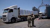 Off Gaza’s coast, truckloads of aid roll off a US military pier – only to remain uncollected