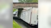 Tractor-trailer struck bridge in DC, wedged underneath: police