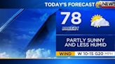 Breezy, less humid with partly to mostly sunny skies today