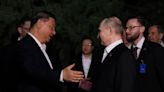 Hugs but not the full socialist-era kiss for Putin, Xi in Beijing