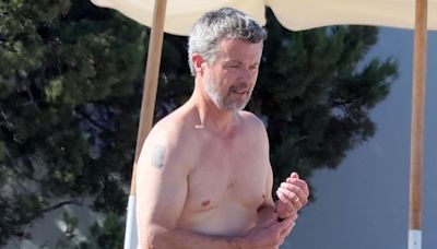 King Frederik of Denmark displays his two tattoos at the beach