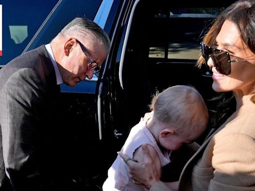 Alec Baldwin arrives at court with wife and baby