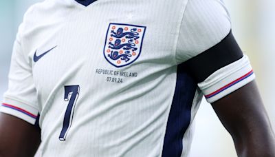 Why are England players wearing black armbands during tonight's match?