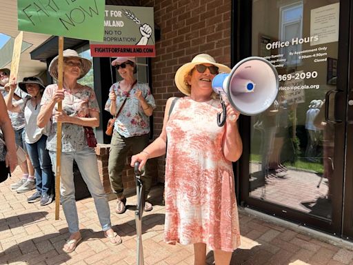 Advocates protest outside MPP Mike Harris' office in response to region's plan to buy up Wilmot farmland