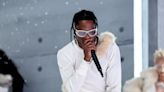 Travis Scott halts concert to order fans to stop dangling from lighting truss amid safety concerns