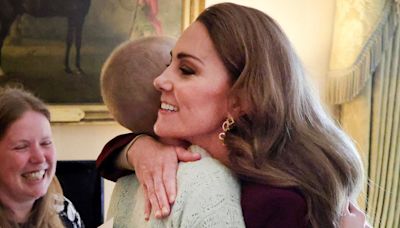 Princess Kate Returns To Work In Burgundy And Embraces Young Photographer Battling Cancer