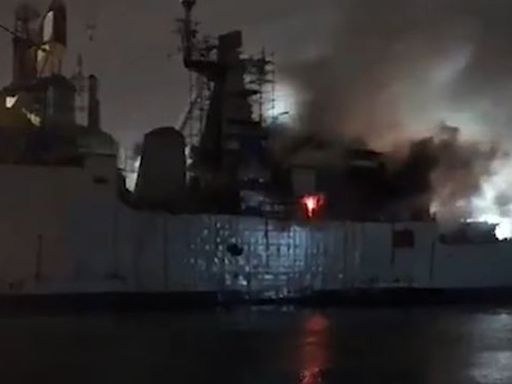 Indian frigate left floating on its side after fire breaks out during repairs