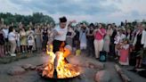 Ukrainians in Warsaw jump over a bonfire, float braids to celebrate solstice custom away from home